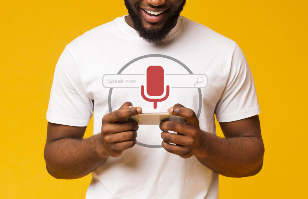 A man is using his phone for voice search.